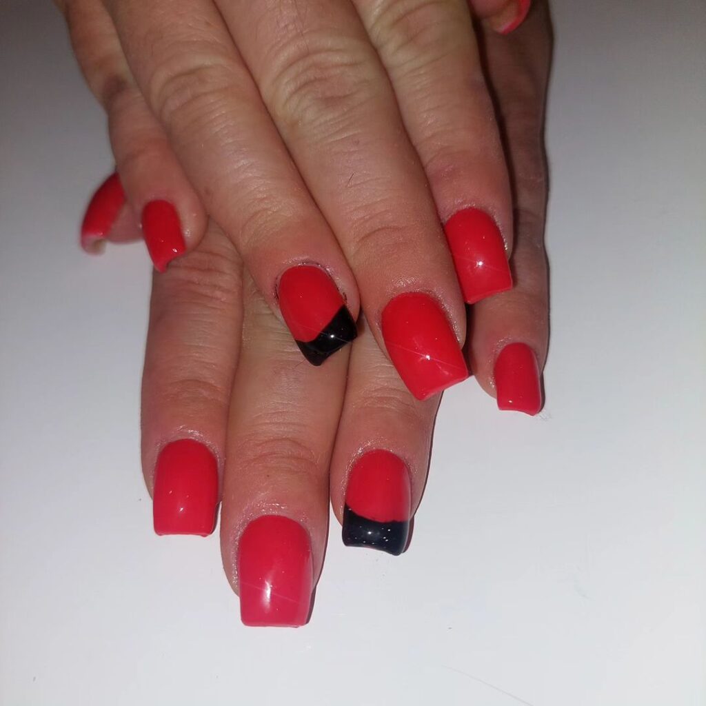 Square red nails with precisely painted white French tipped designs