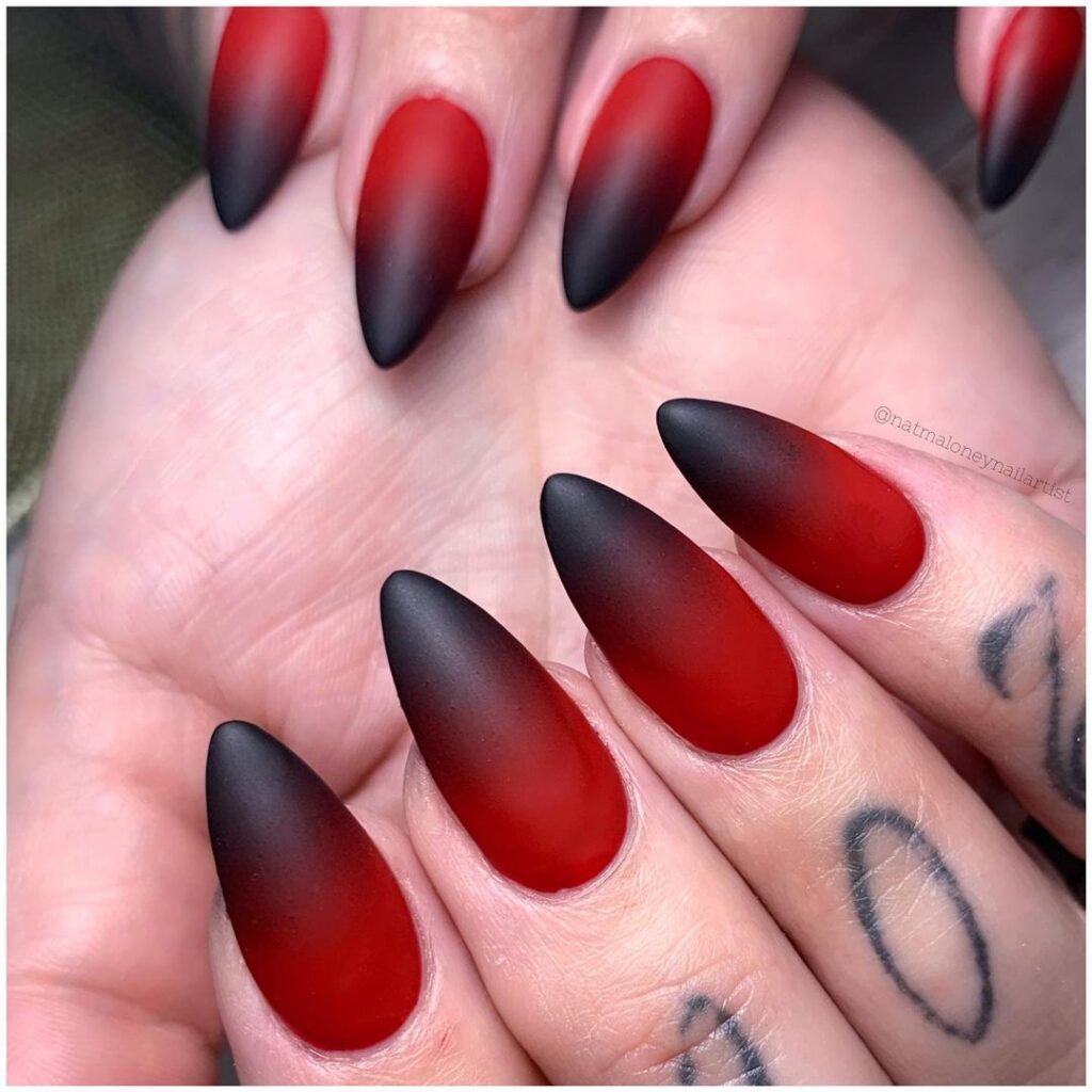 Square nails painted matte red and matte black.