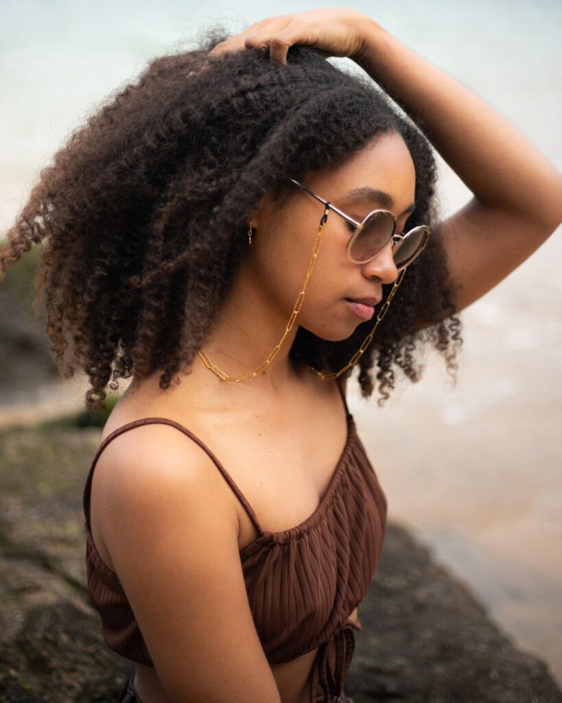 Woman with glasses sporting afro haircut