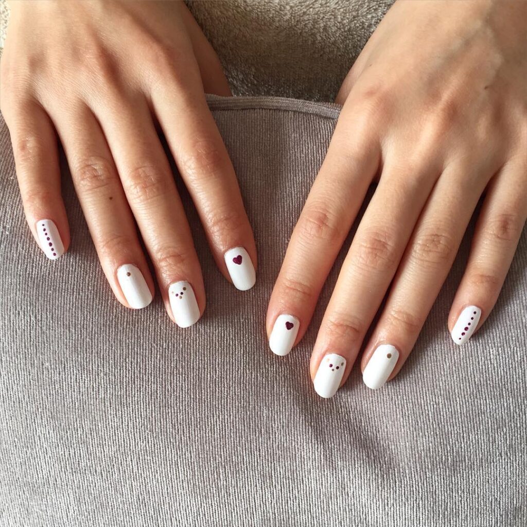 White almond nails with heart designs