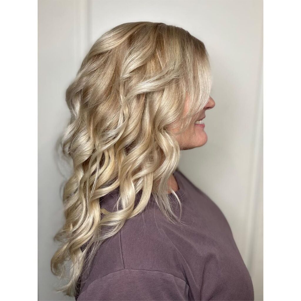 Curly layered blonde hair, medium length