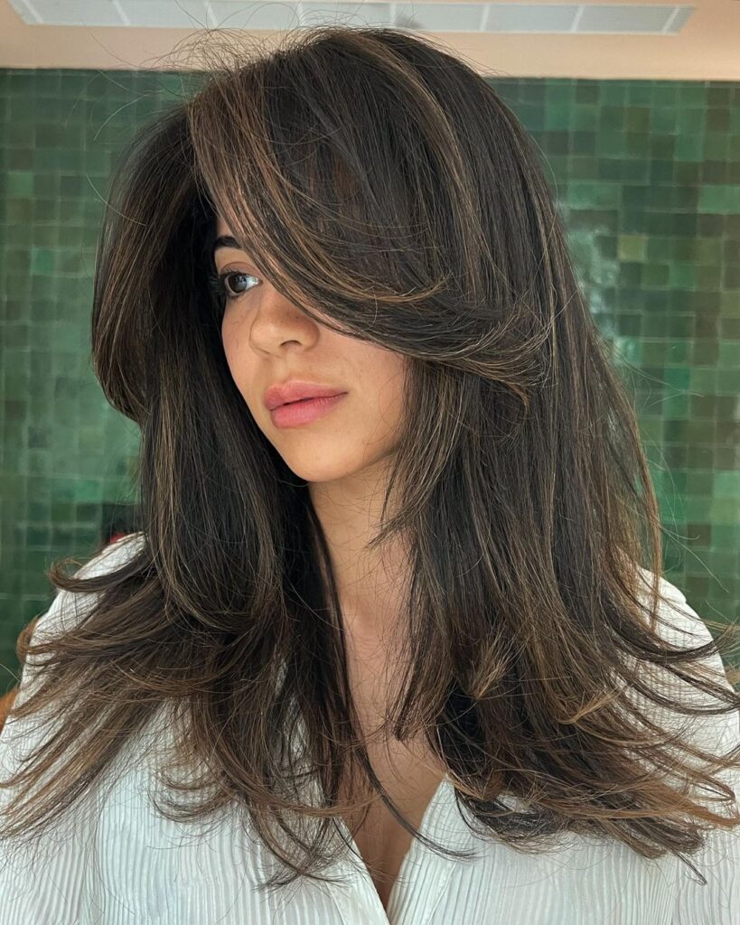 Shoulder-length hair with layers and bangs