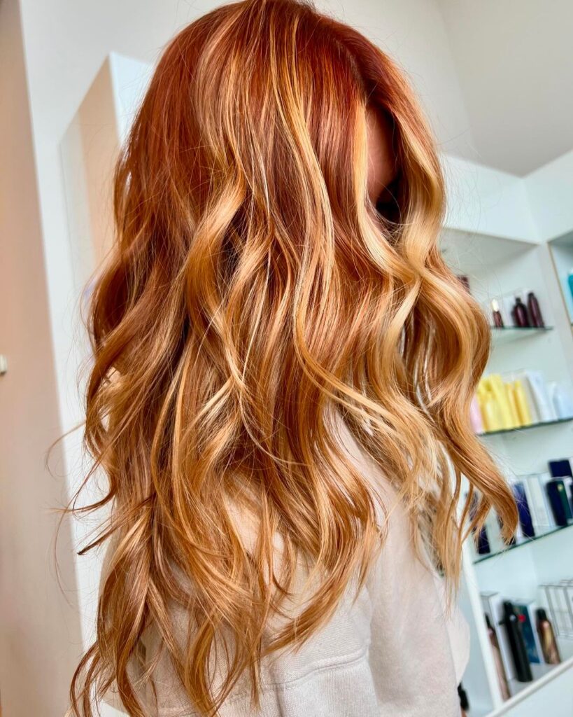 Wavy copper-blonde hair with layered cut