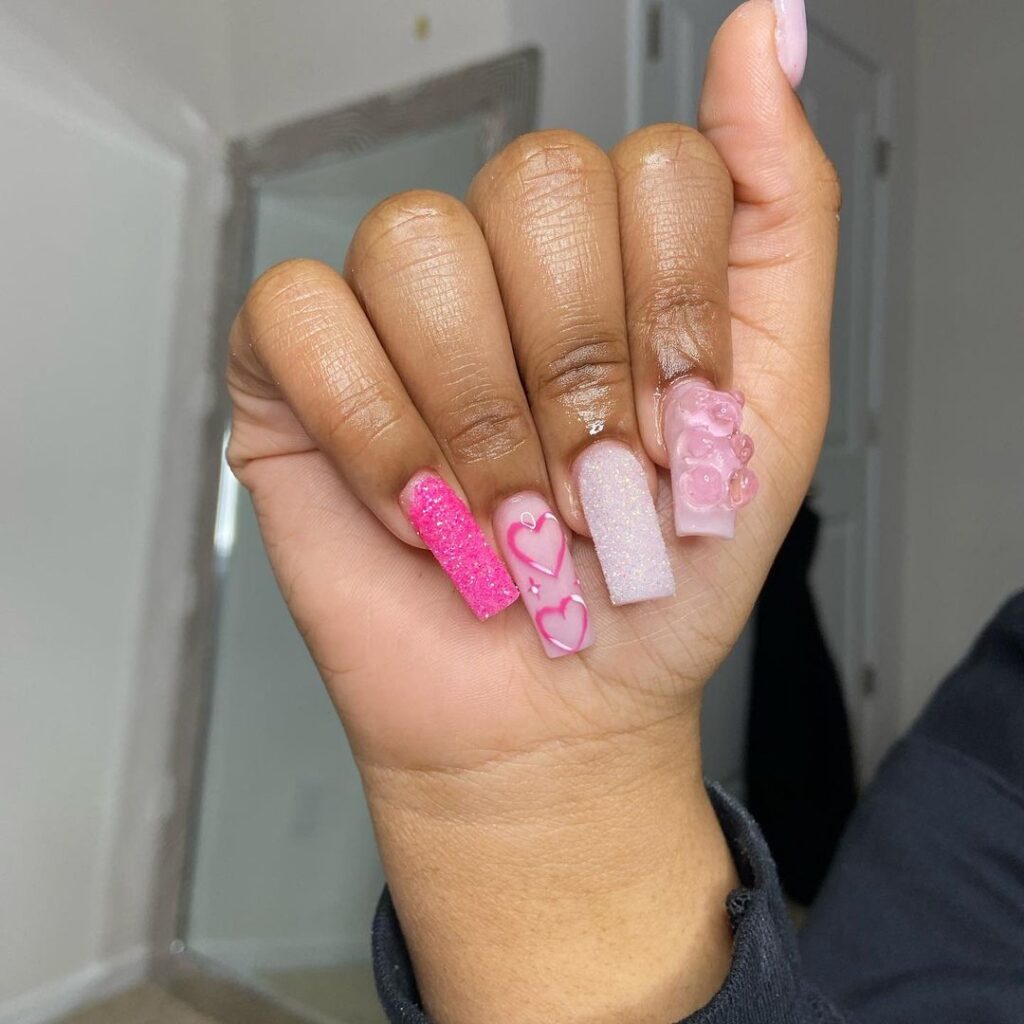 Pink square nails with gummy bear designs