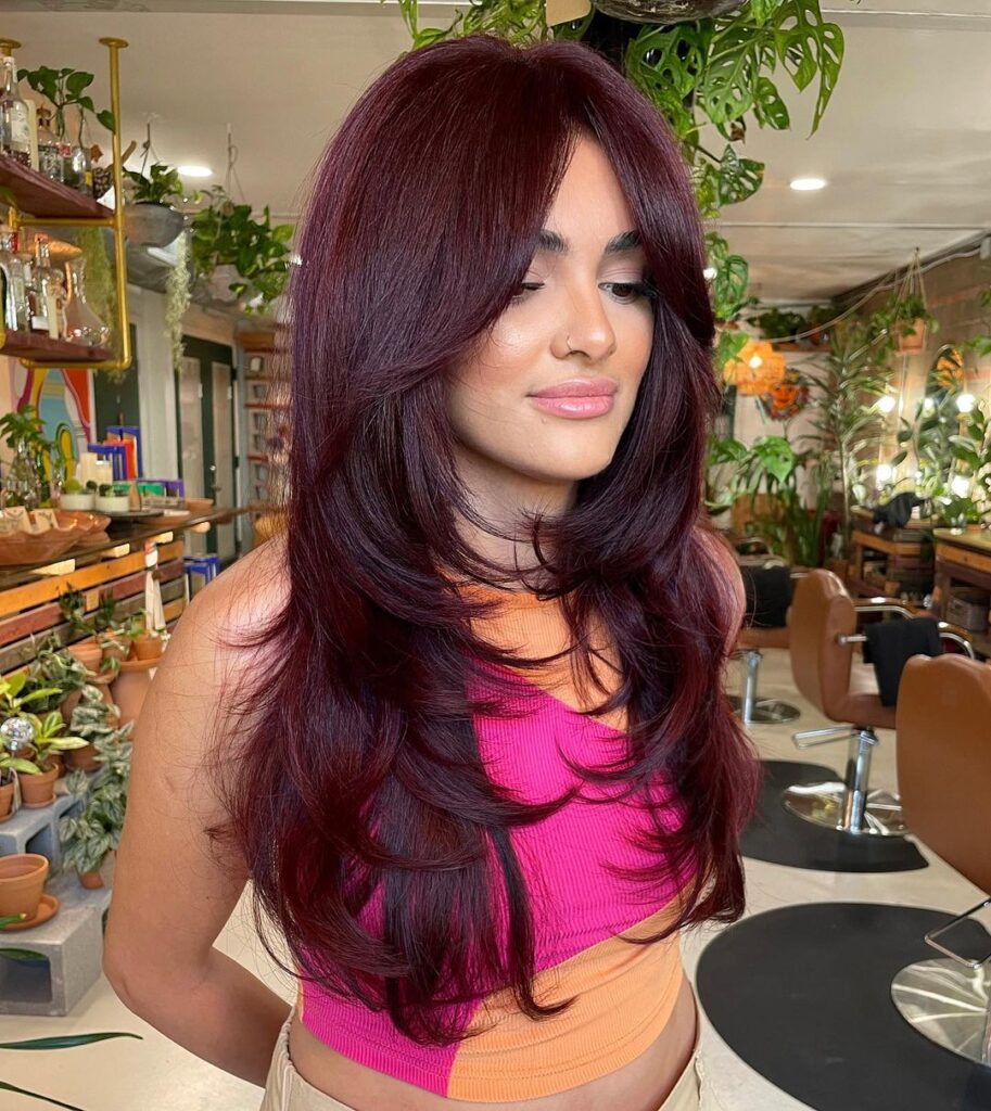 Long red hair, wispy layered cut