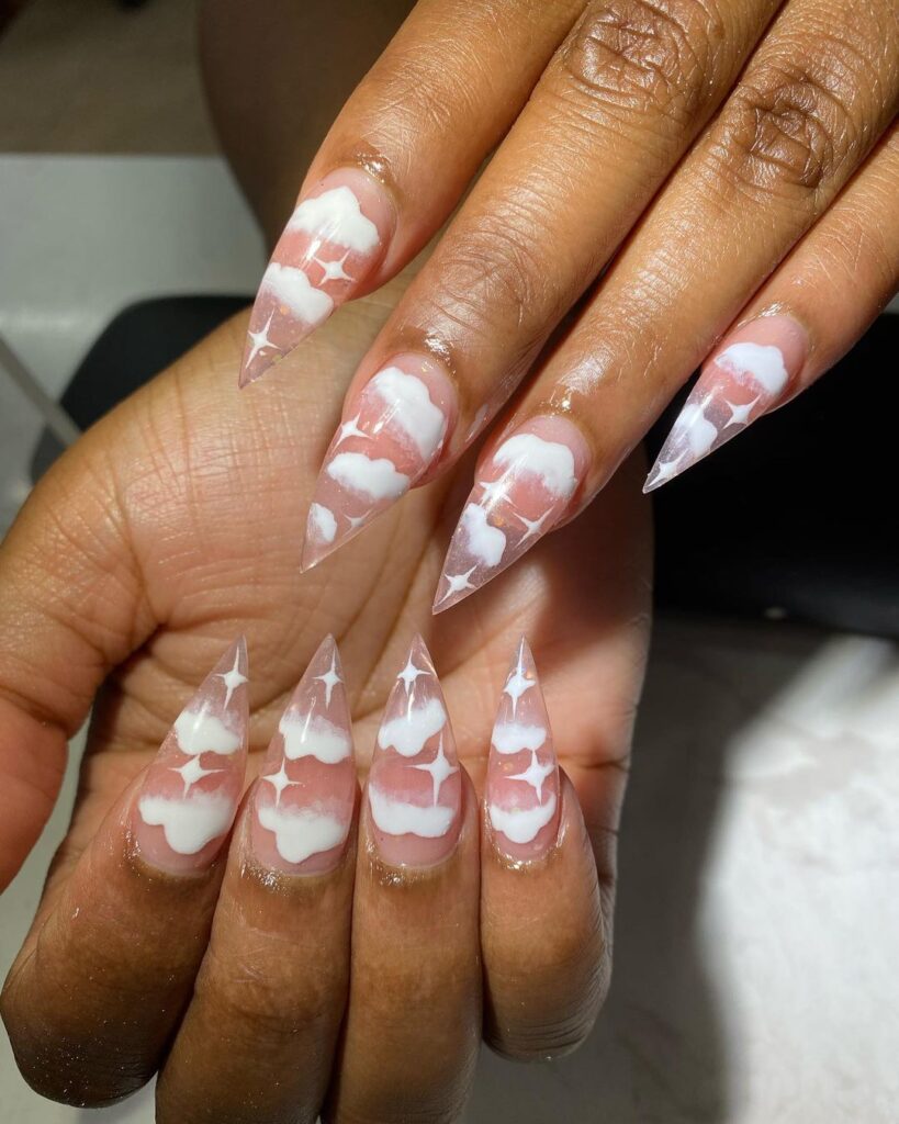 Pink marbled stiletto-shaped nails with accents