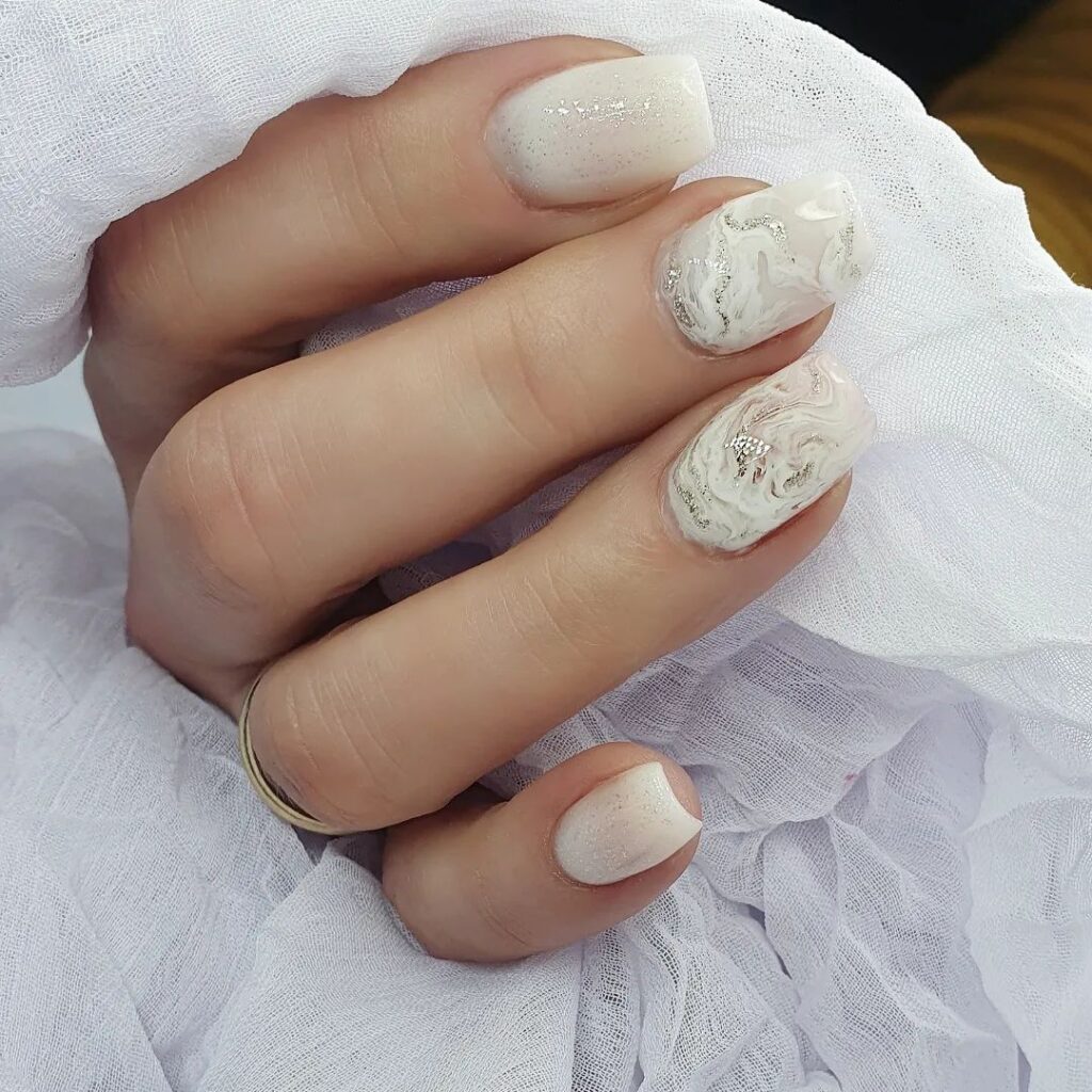 Short white nails, marble swirls, elegant