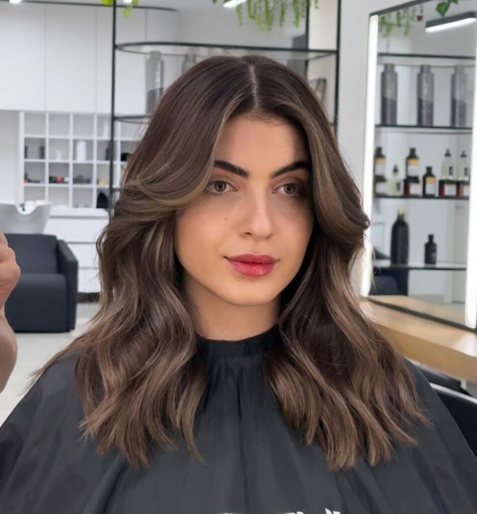 Layered mid-length hair with curtain bangs