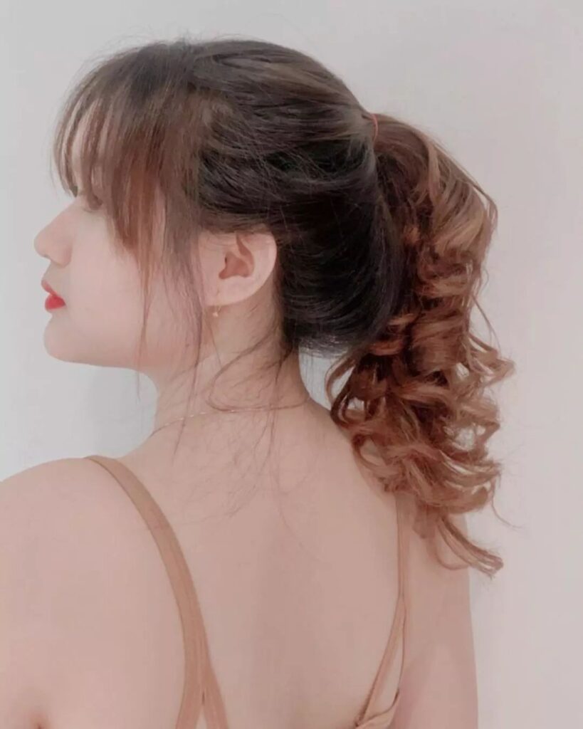 High ponytail with messy curls, curly bangs