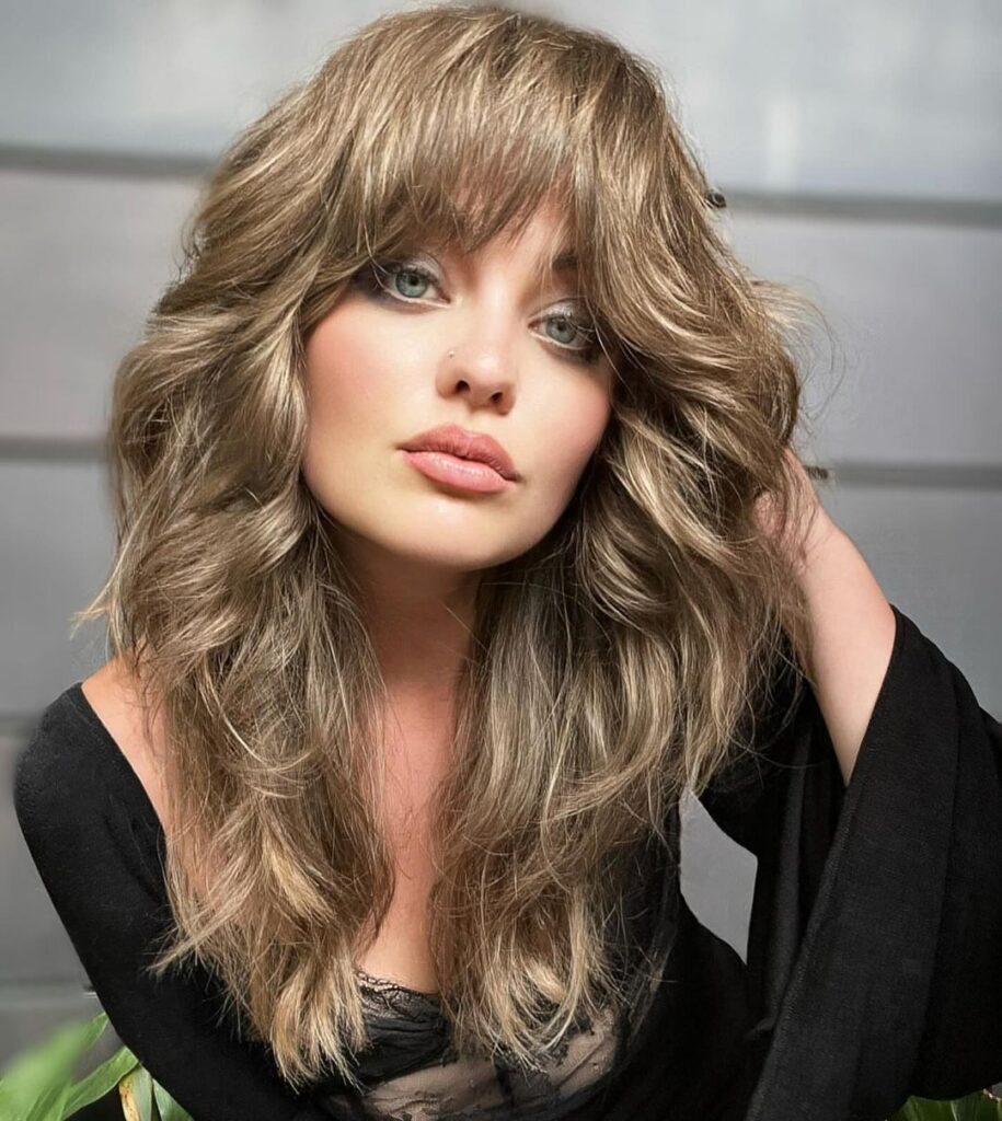 Textured hair with thick bangs and layers