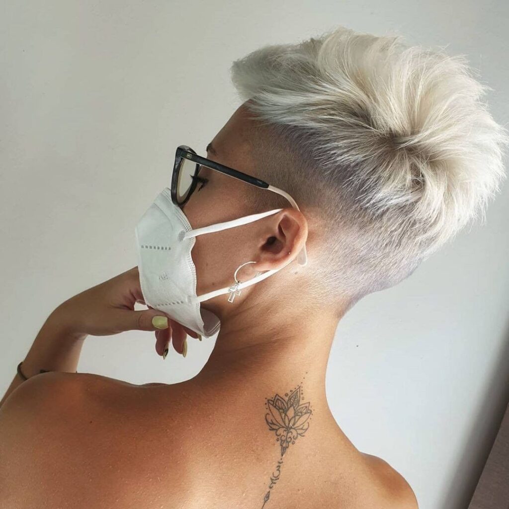 Pixie cut with shaved undercut, glasses