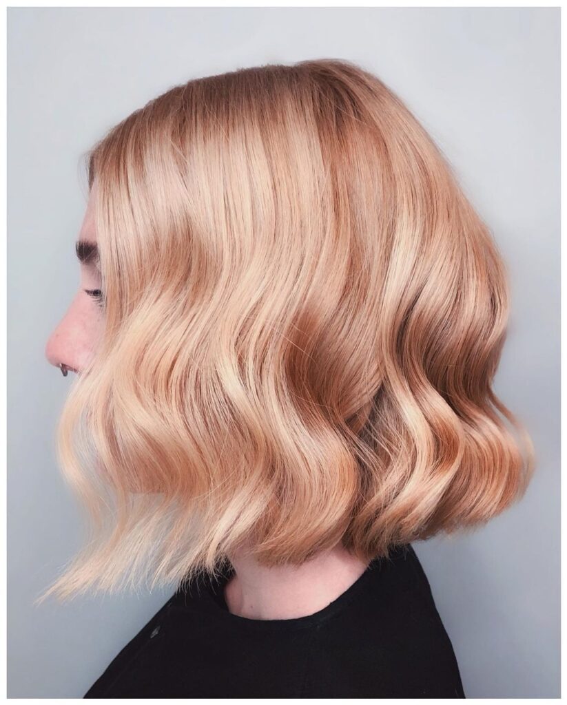 Voluminous golden waves in short hair