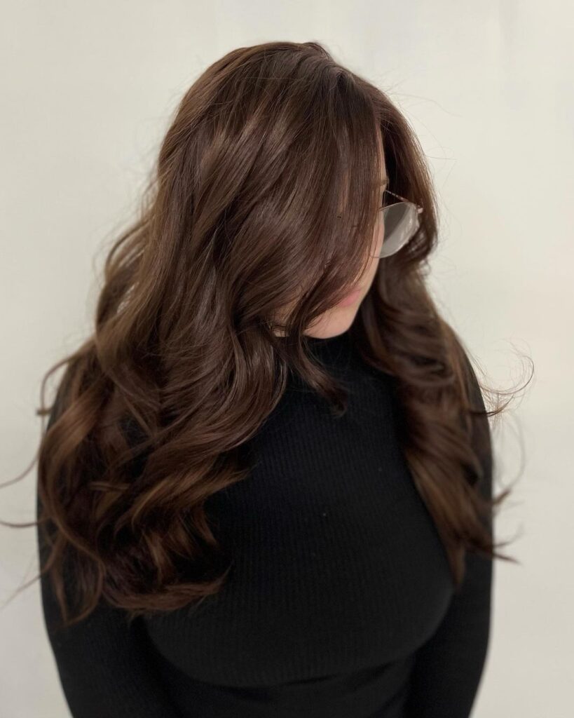 Chocolate brown hair with warm balayage highlights