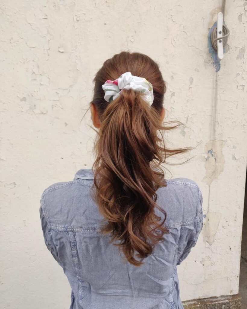 Sleek chocolate brown hair in ponytail