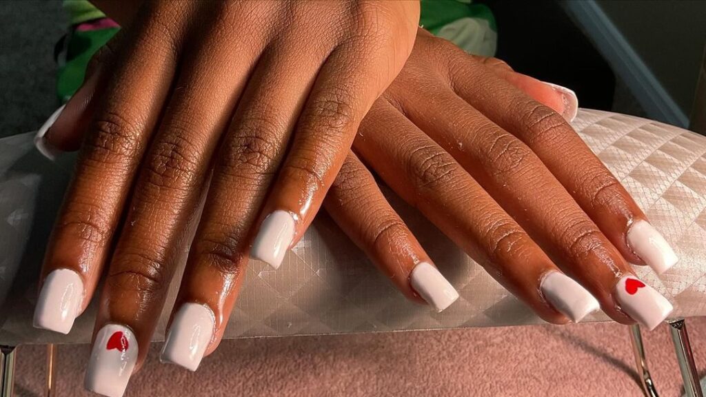 White nails with dainty heart accents