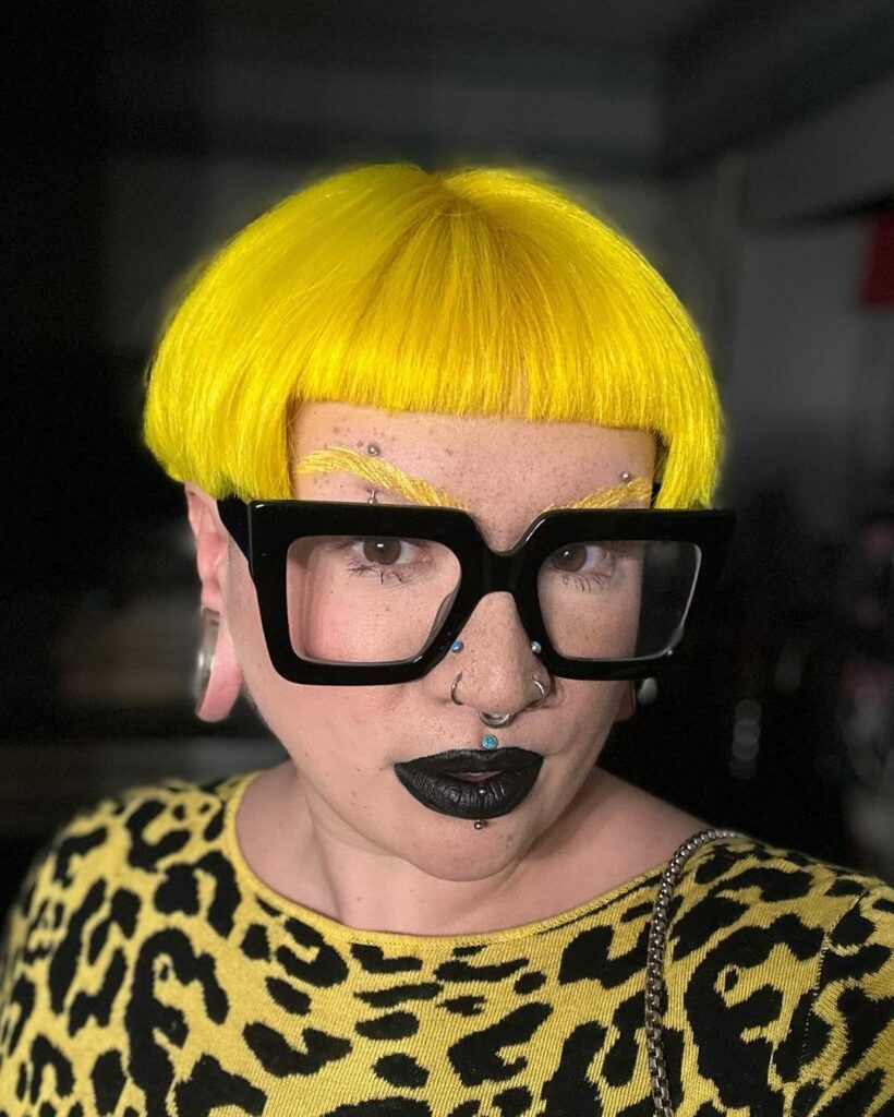 Bright yellow bowl cut with glasses