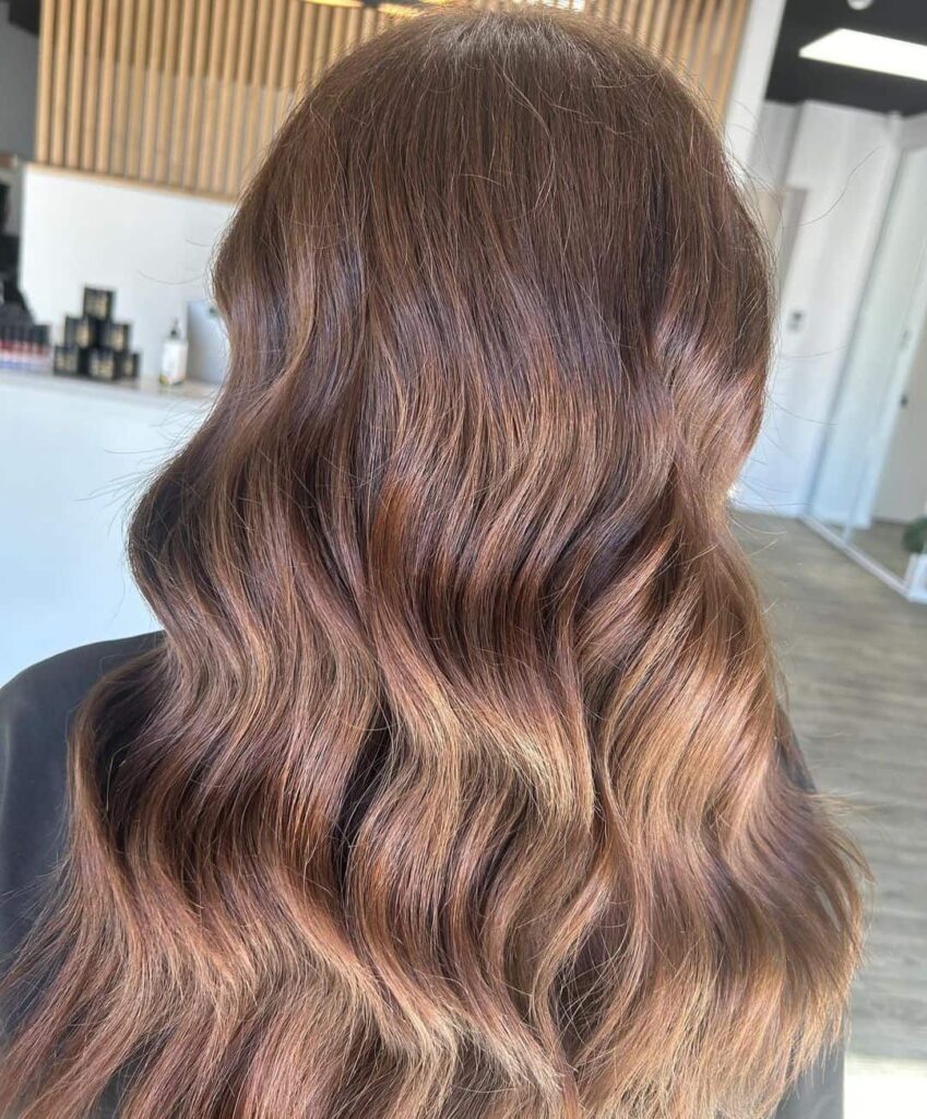 Wavy brown hair with caramel highlights