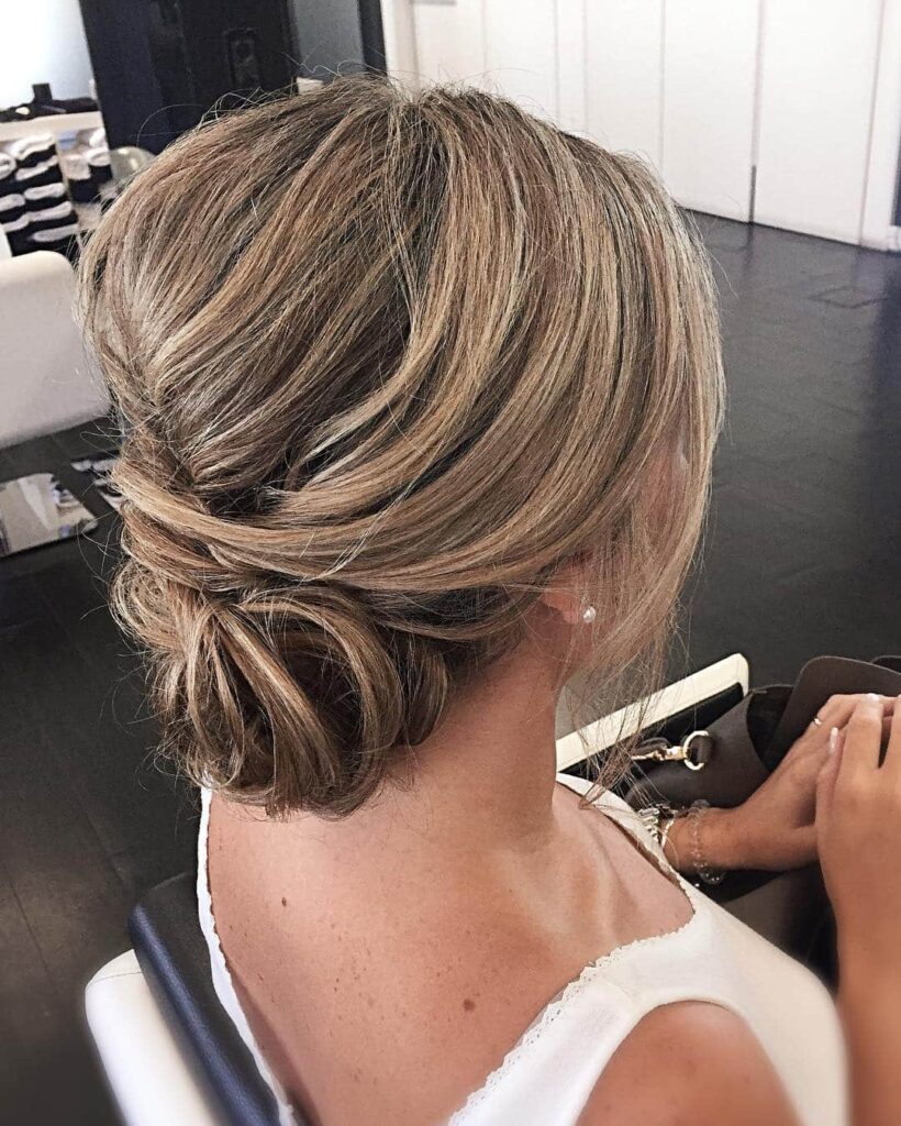 Textured low bun, blonde highlights, spring-ready