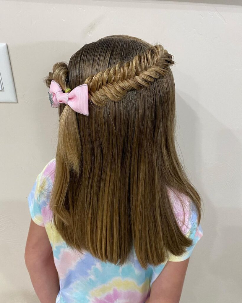 Half-up fishtail braid, pink bow, school-ready style