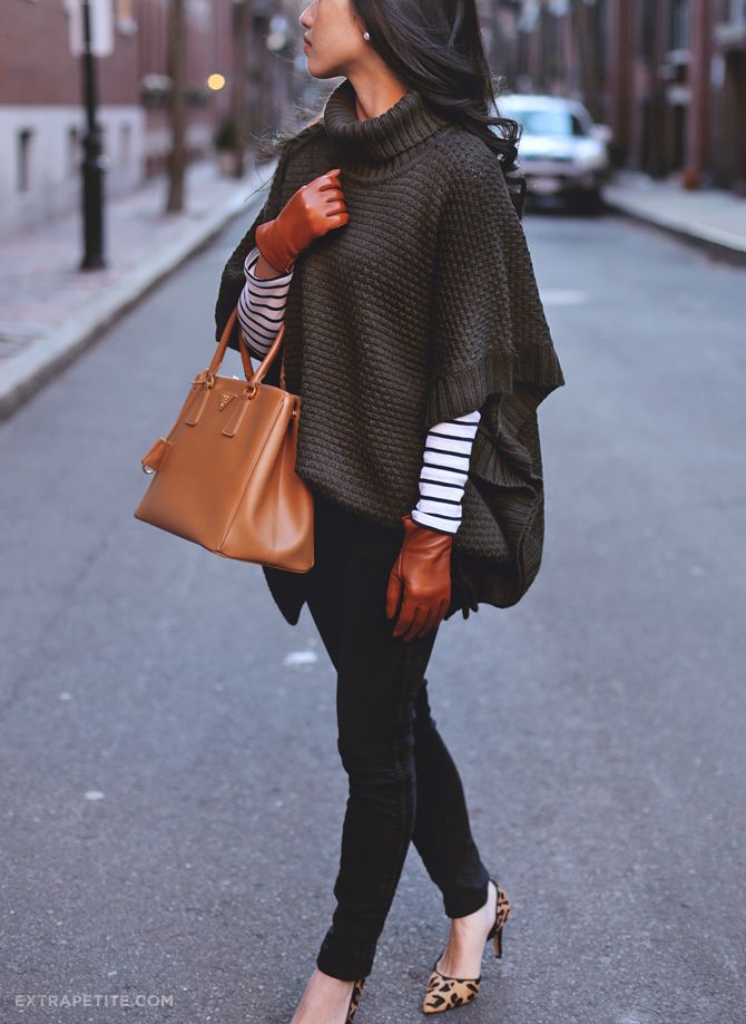 "Cozy knit poncho layered over jeans for a stylish, casual outfit."
