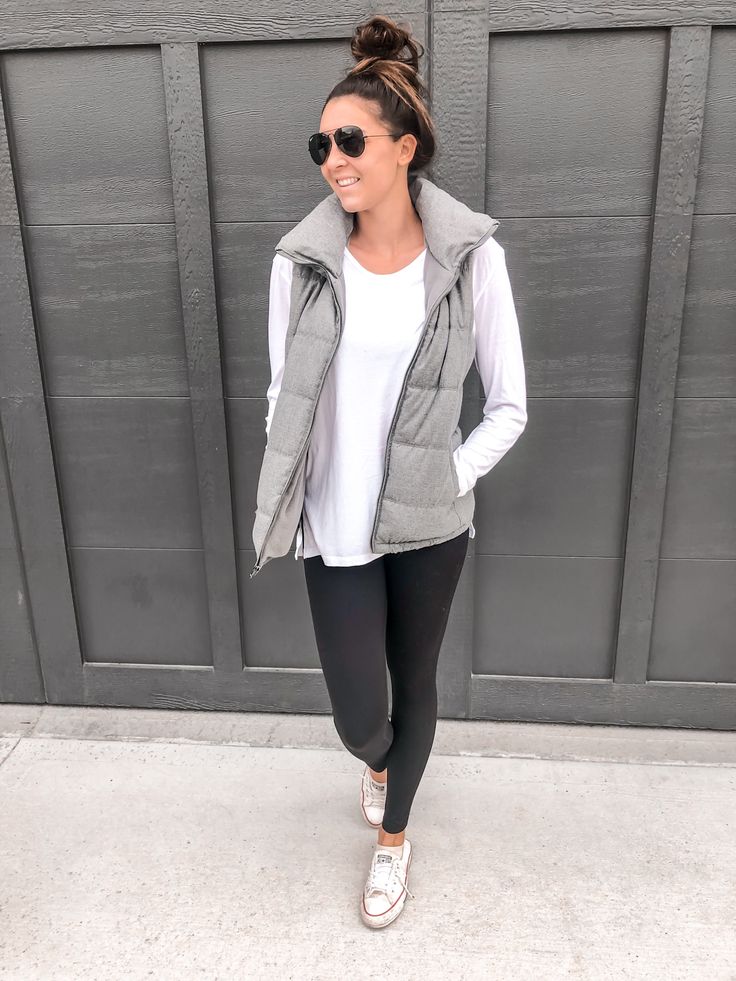 "Stylish puffer vests over long sleeve tees for warmth and flair."