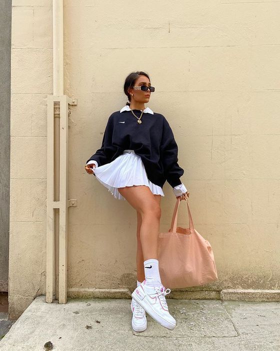 "Casual sweatshirt styled with a feminine skirt for a fun mix of comfort and style."