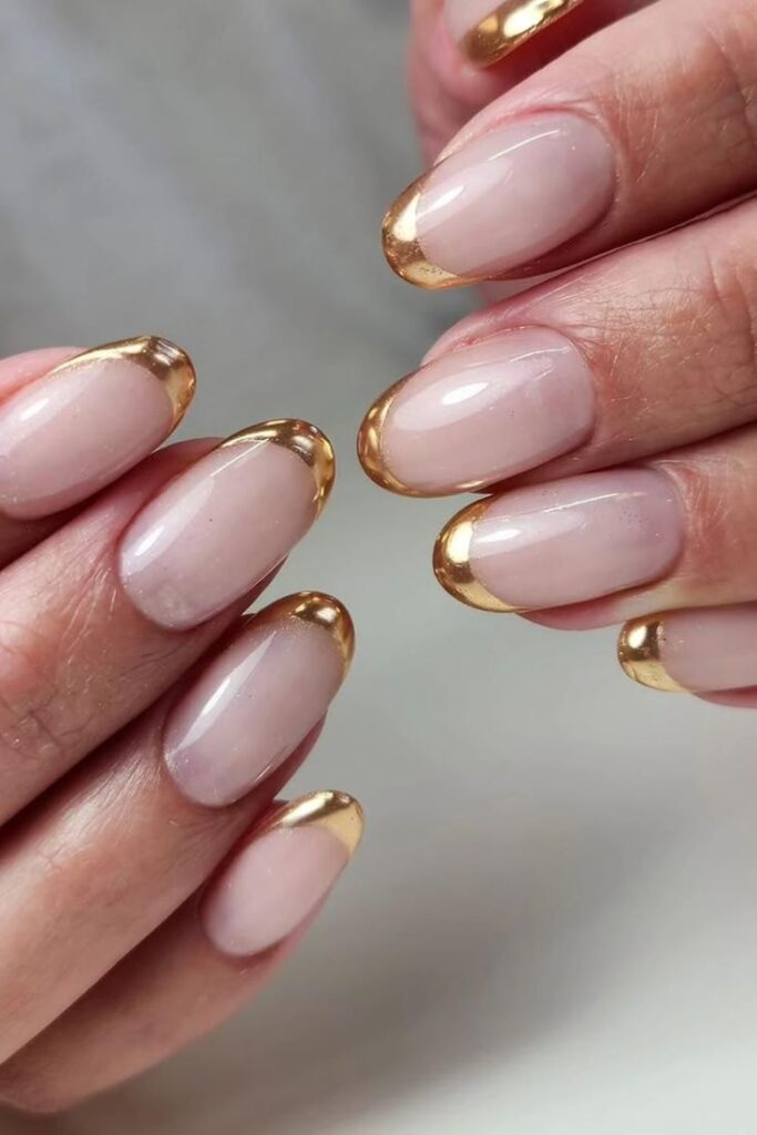 Nude almond nails with gold stripes
