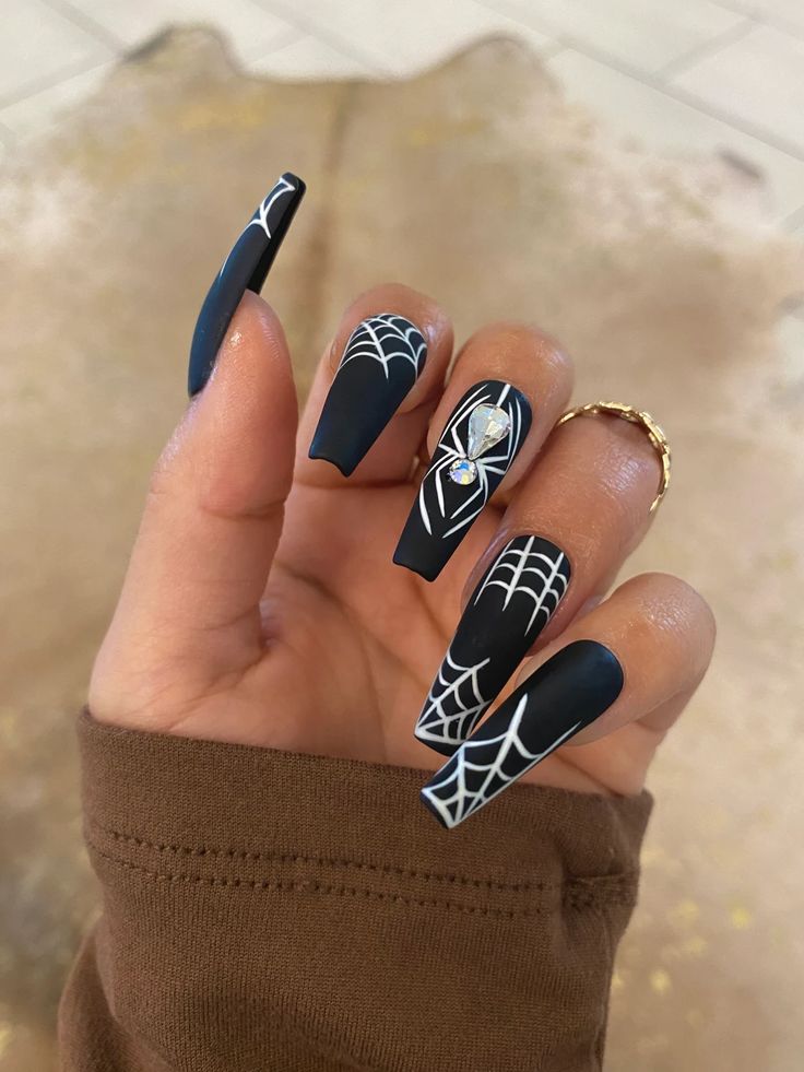 Spooky web-themed nail design